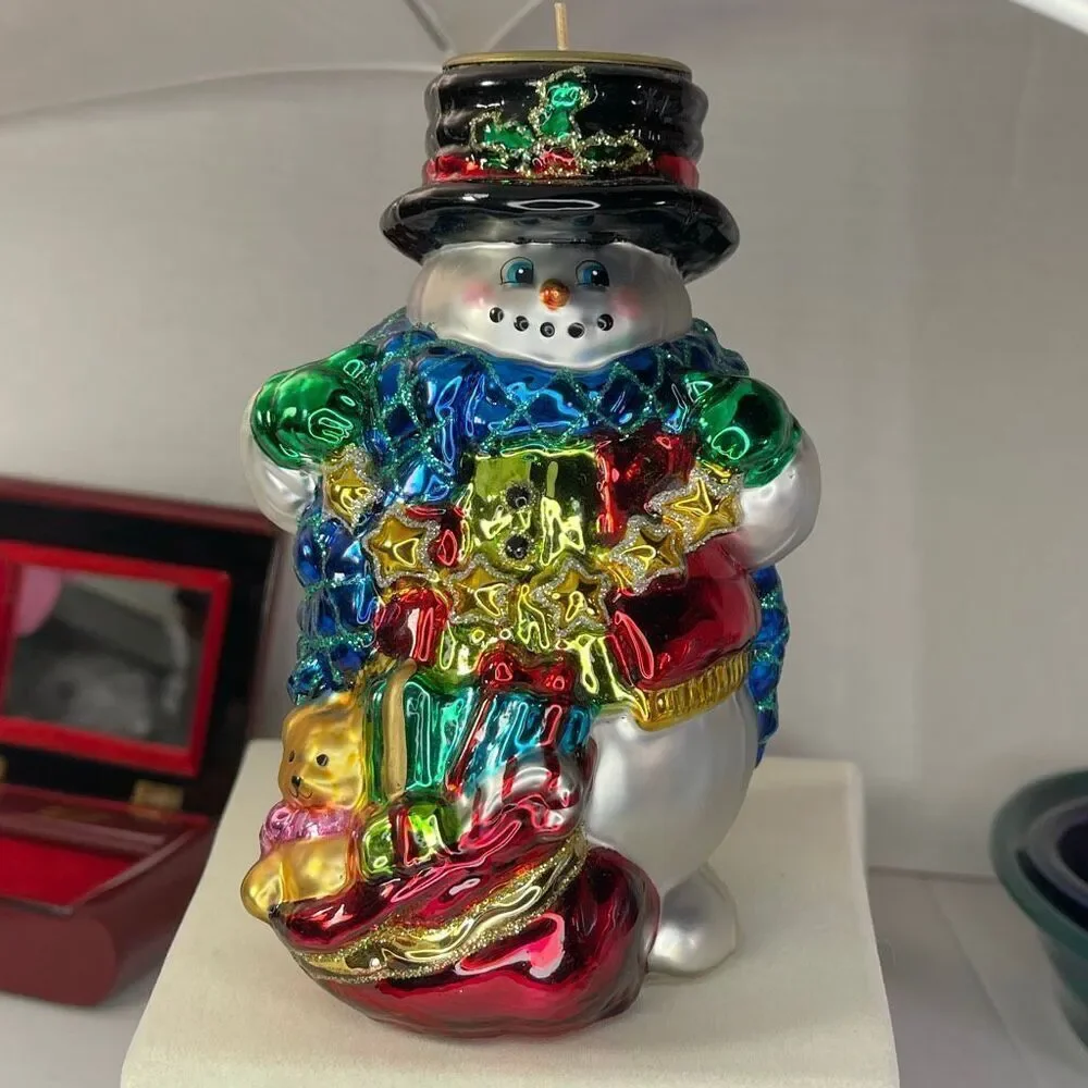Charming hand-blown mercury glass snowman candle holder.